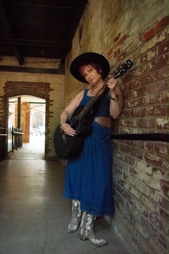Randie O’Neil holding her guitar